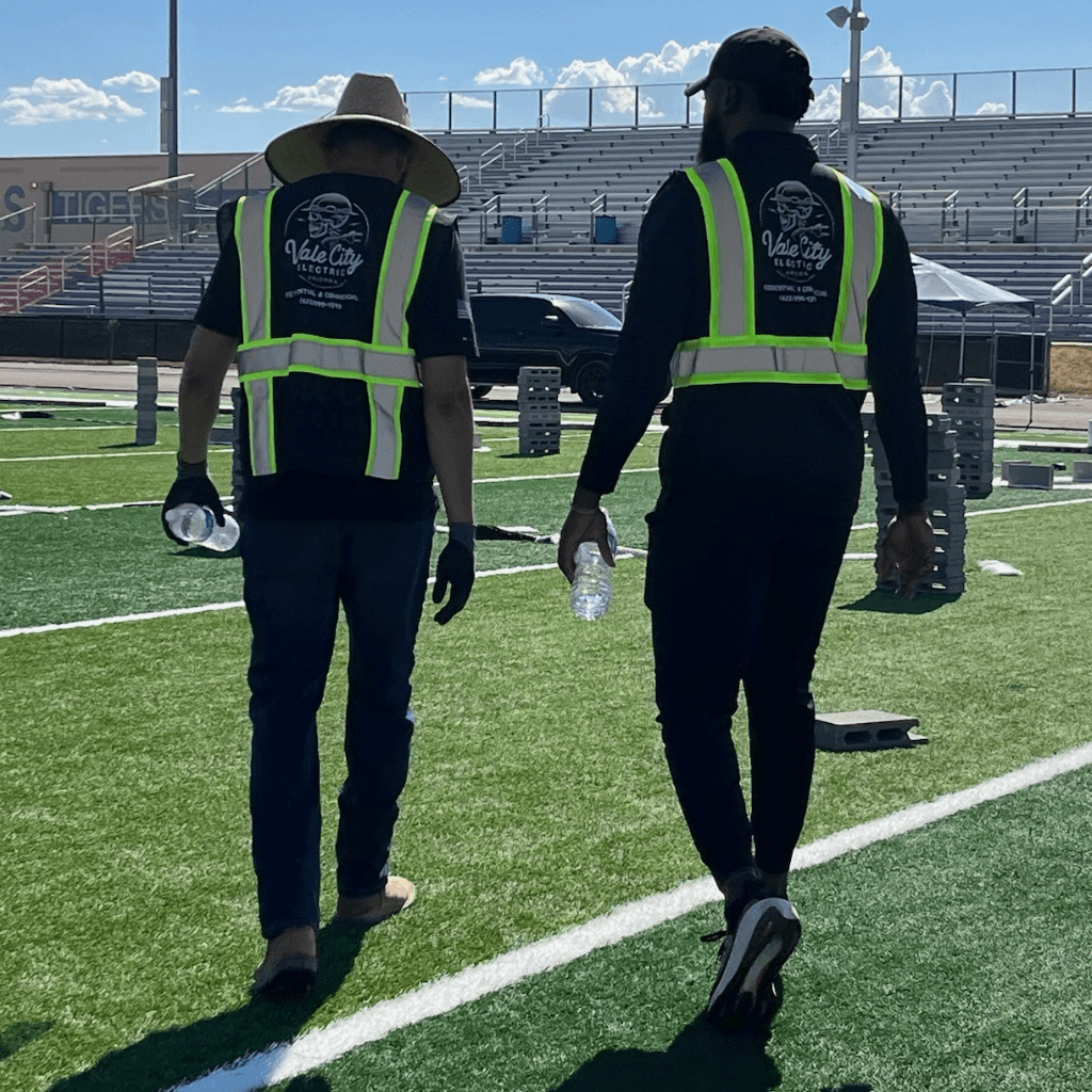John Crowder and Jesus Enriquez of Vale City Electric walking the field at Millennium High School in Goodyear Arizona during a commercial tenant improvement project