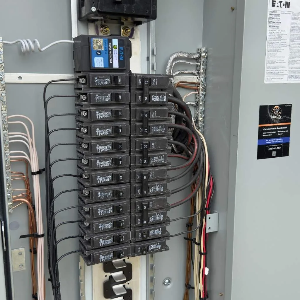 Interior view of a newly installed 200 amp electrical panel with clean wire management and organized breakers in South Scottsdale Arizona by Vale City Electric.